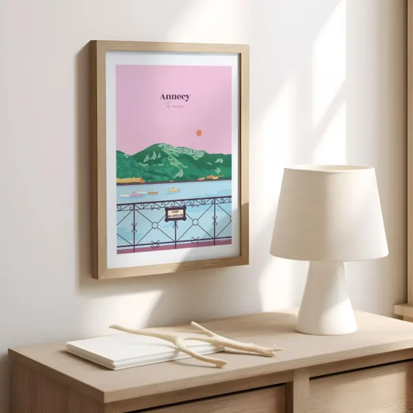 Une affiche sur un mur dans le bureau illustrant le lac d'Annecy et le Pont des Amours