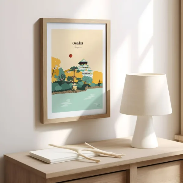 Une affiche sur un mur dans un bureau illustrant le château d'Osaka et ses jardins