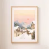 Une affiche représentant un village de Noël dans les tons beiges et roses accrochée au mur