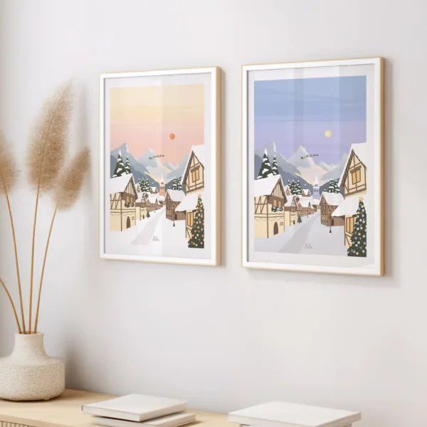 2 affiches représentant un village de Noël dans 2 couleurs différentes accrochée au mur au dessus d'un meuble